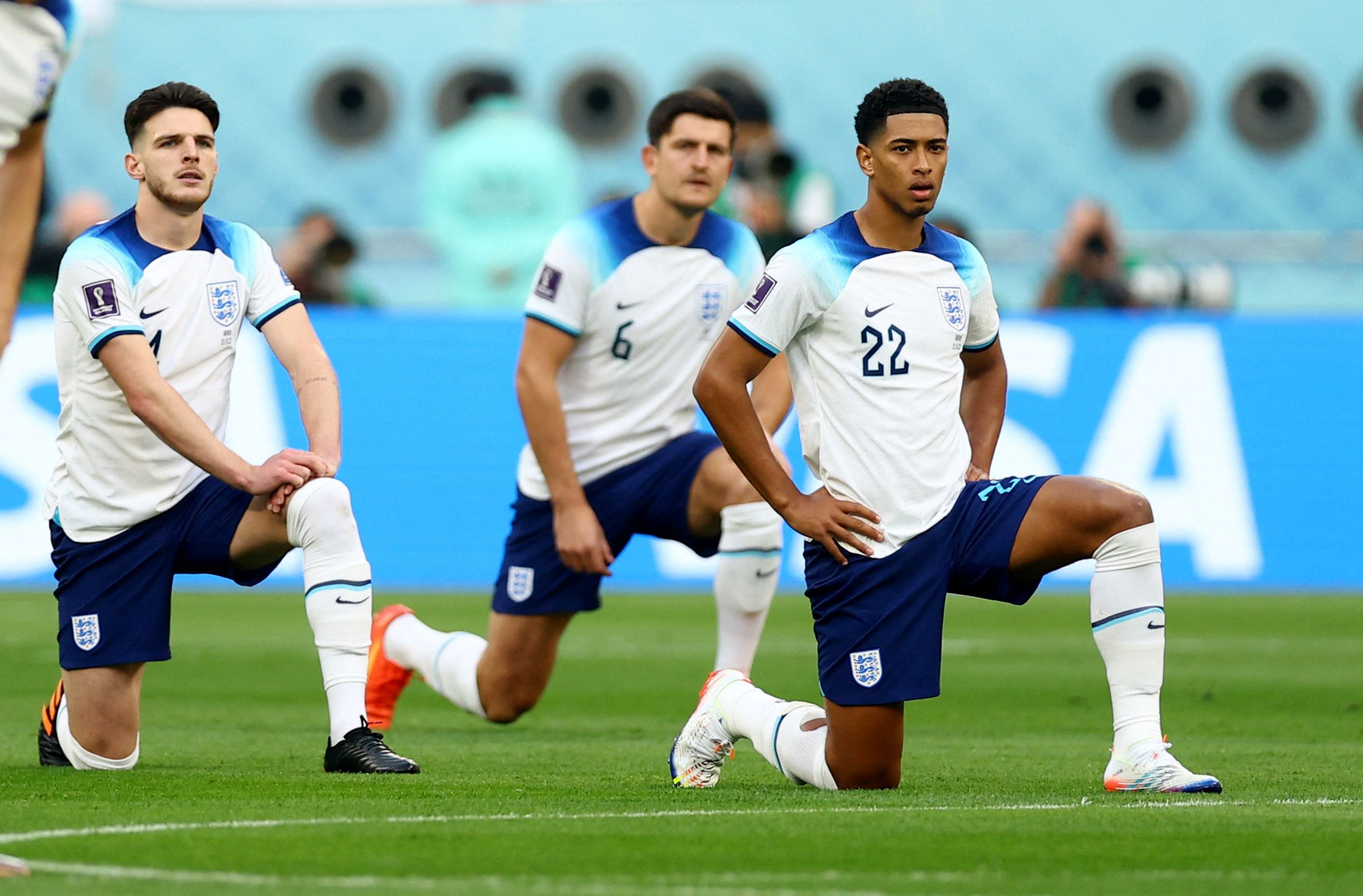 England's Jude Bellingham and Declan Rice take the knee before the match against Iran. (November 21, 2022)