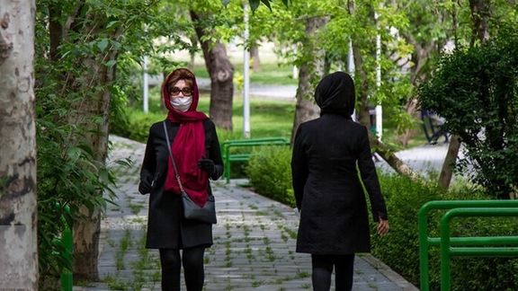 Women walking in a Tehran park, with attire satisfying minimum hijab rules.