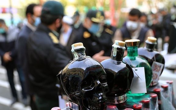 Authorities display confiscated bootleg liquor. (File photo)