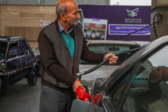 A man fills up his car at a gas station in Iran's northeastern province of Khorasan Razavi, December 2023