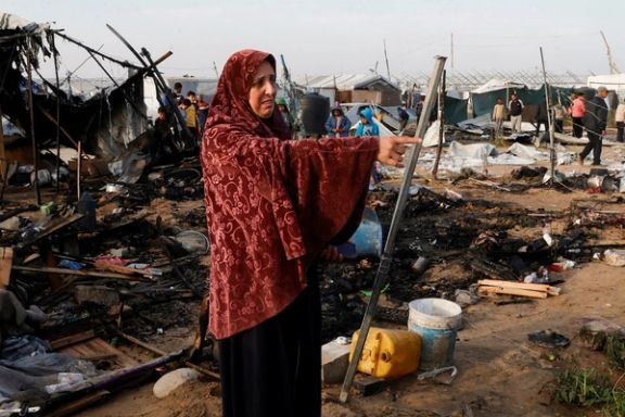 A Palestinian woman gestures as people inspect the site of an Israeli strike on a tent camp housing displaced people, in Al-Mawasi area, in Khan Younis in the southern Gaza Strip March 18, 2025.