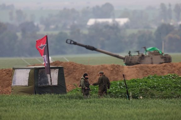 Israeli soldiers stand at an artillery position, amid the ongoing conflict between Israel and Iran-backed Islamist group Hamas, near the Israel-Gaza border, as seen from Israel, February 19, 2024.