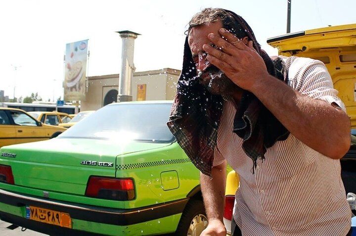 A taxi driver splashes water on his face to find relief from the intense heat during a heatwave in Iran (Undated)