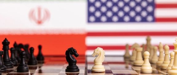 Chess pieces are seen in front of displayed Iran's and US flags in this illustration taken January 26, 2022.