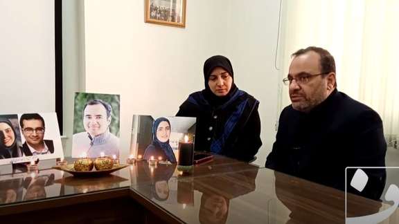 The Asadi-Lari family during a previous interview on January 2, with photos of their children.