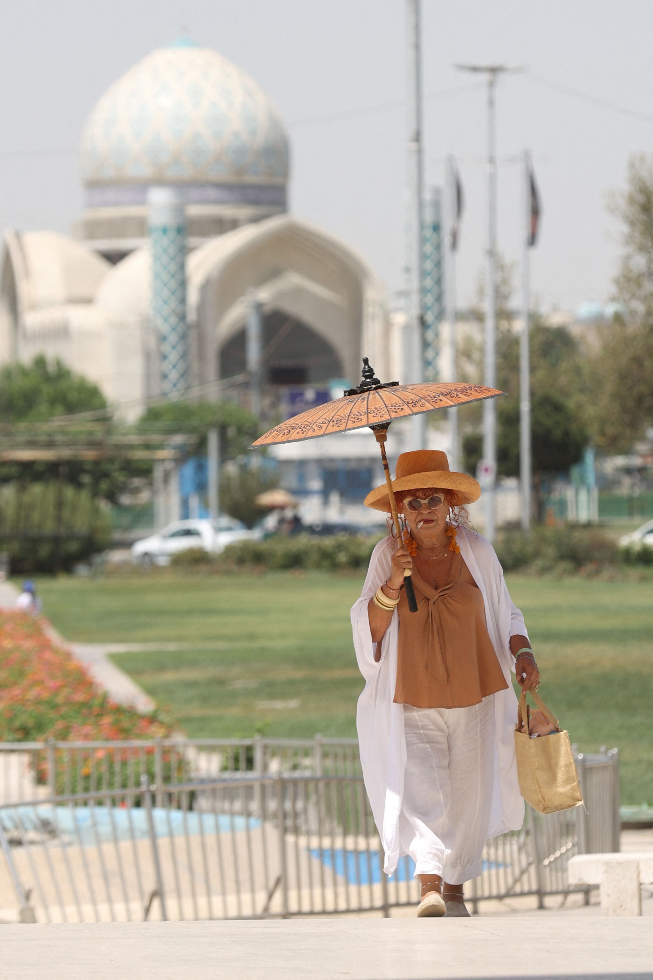 A woman walks in a street during the heat surge in Tehran, Iran, August 2, 2023. 