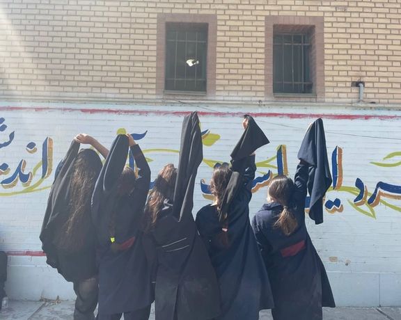 A group of students unveiling at school in support of the ongoing protests across Iran