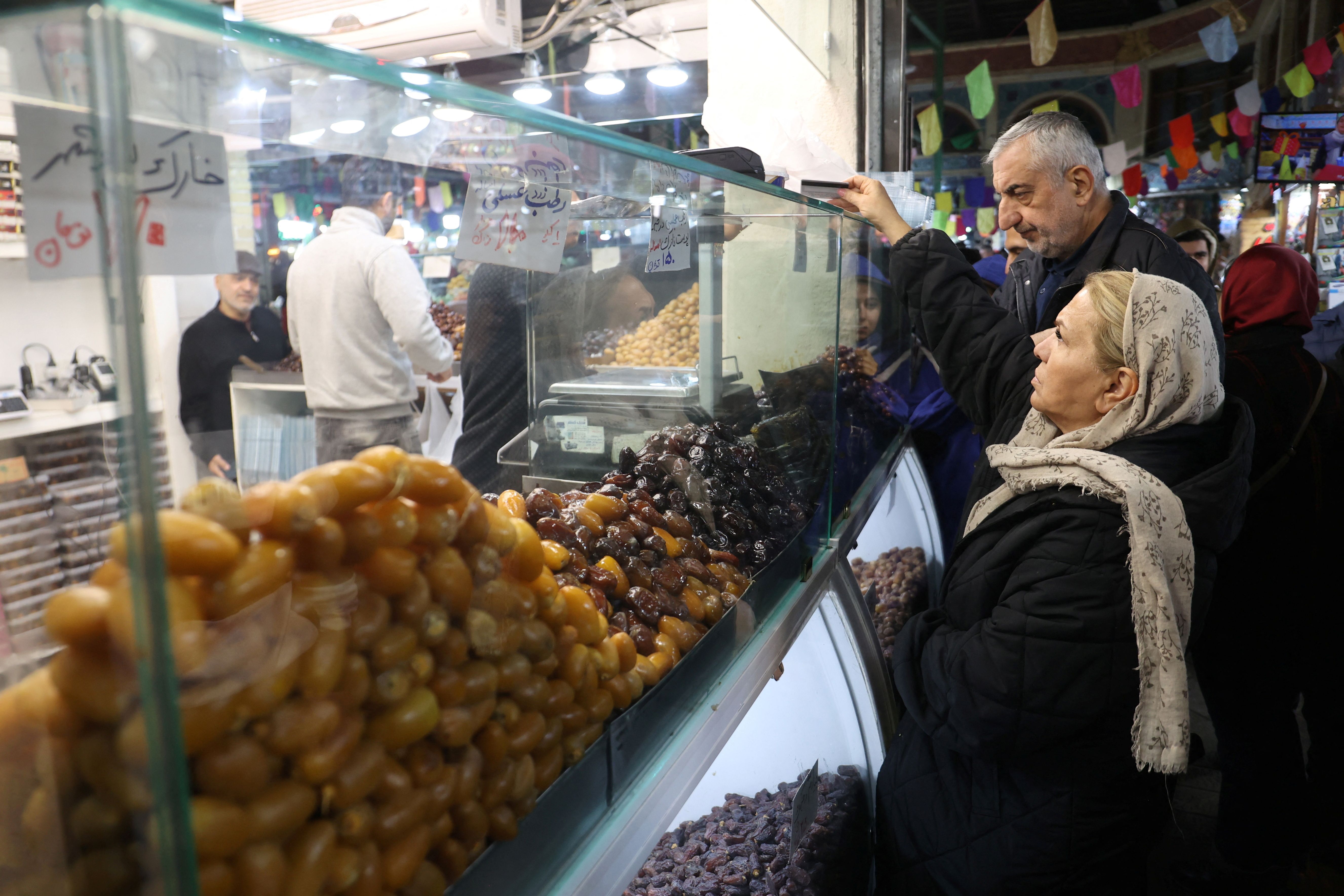 A woman shops during the holy month of Ramadan in Tehran, Iran, March 11, 2024. 