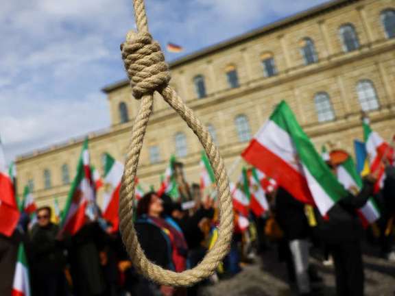 A noose is seen as people hold Iranian flags during a protest on the day of the Munich Security Conference, in Munich, Germany February 17, 2023.