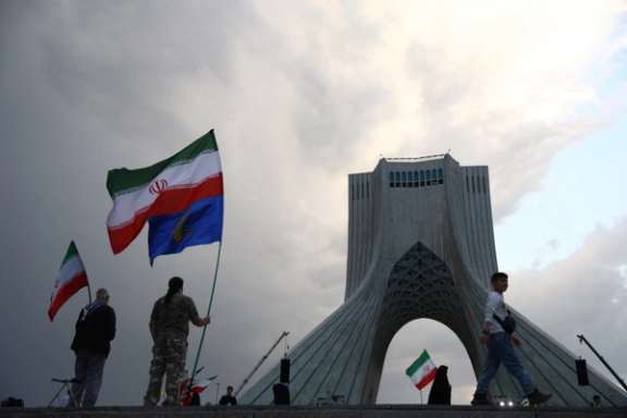 People hold Islamic Republic and Revolutionary Guards flags during a pro-government rally in Tehran, Iran, April 29, 2026.