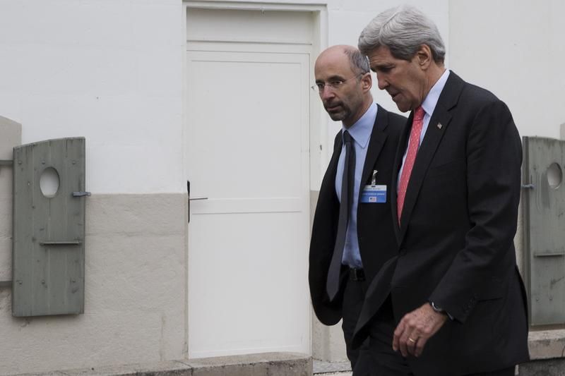 Then-US Secretary of State John Kerry walks to lunch with members his negotiating team, including Robert Malley (L) from the U.S. National Security Council, following a meeting with Iran's Foreign Minister Javad Zarif over Iran's nuclear program in Lausanne March 20, 2015.