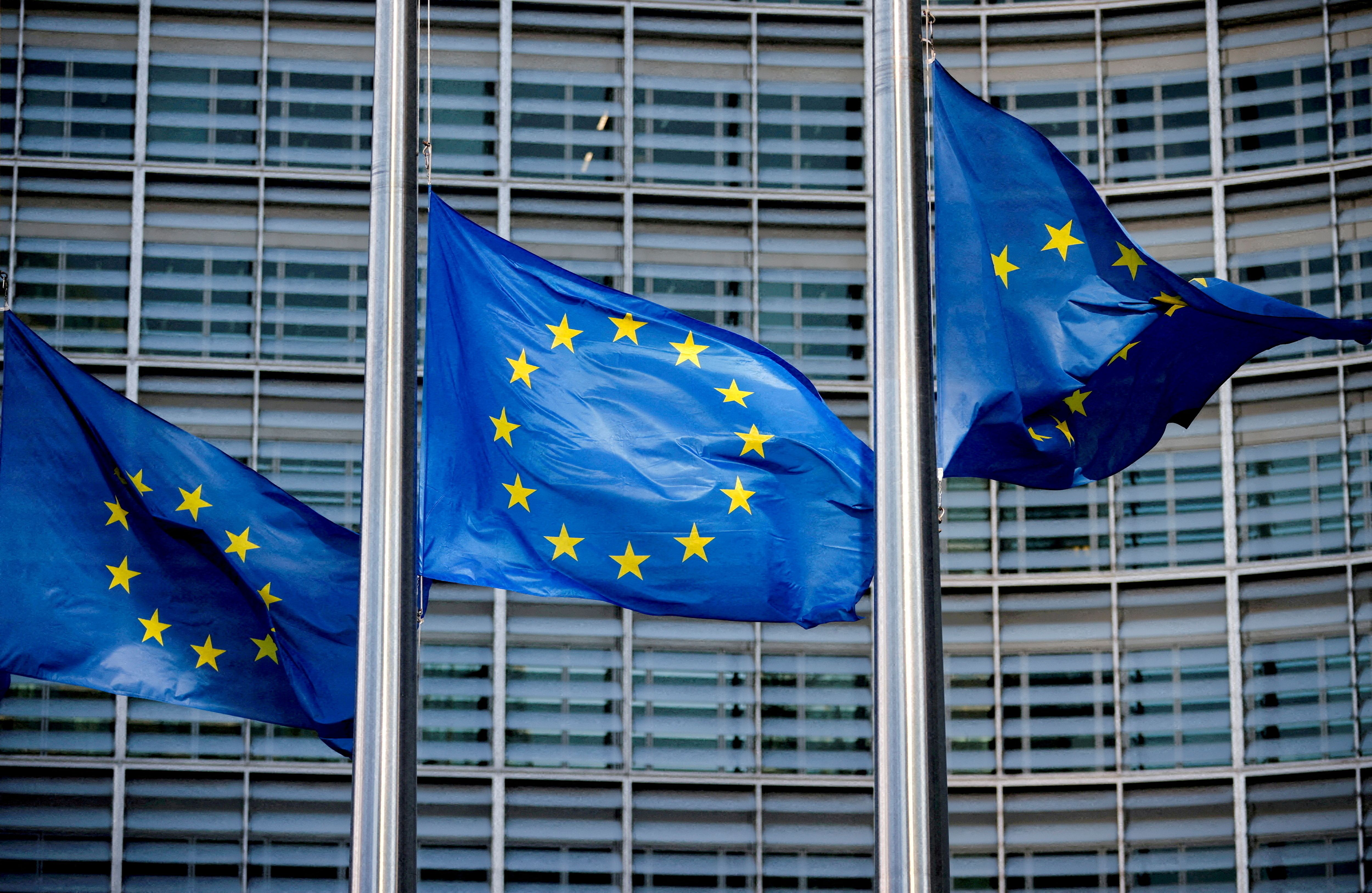 European Union flags fly outside the European Commission headquarters in Brussels, Belgium.