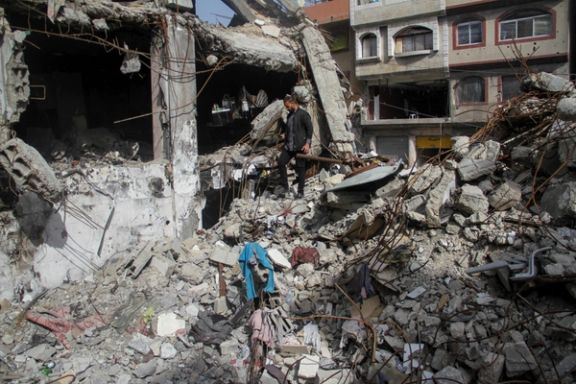 A Palestinian man walks through the rubble of his shop which was destroyed in an Israeli strike, in Jabalia in the northern Gaza Strip March 31, 2024.