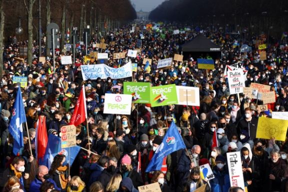 Demonstrators carry flags and placards as they take part in an anti-war protest in Berlin, after Russia invaded Ukraine. February 27, 2022.