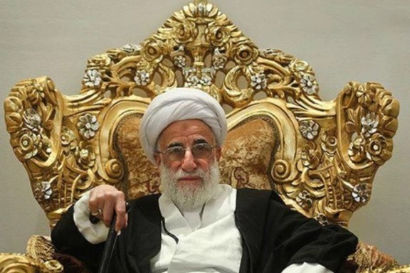 Ahmad Jannati, 96, sitting in an oppulant chair. Undated