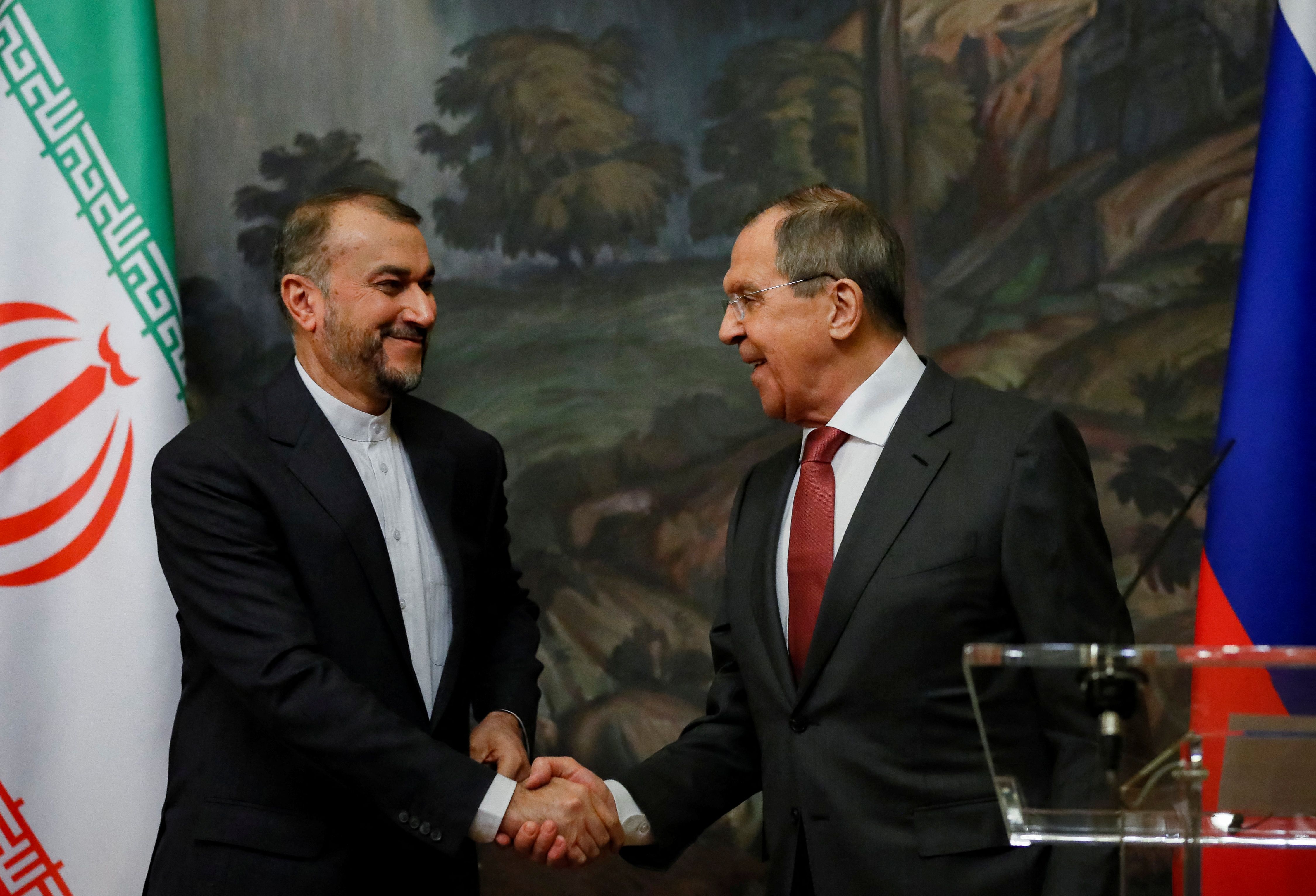 Russian Foreign Minister Sergei Lavrov shakes hands with Iranian Foreign Minister Hossein Amir-Abdollahian during a news conference following their meeting in Moscow, Russia March 29, 2023. 