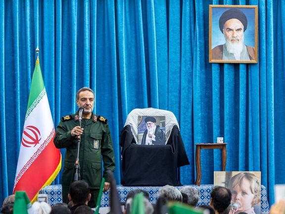 An IRGC commander speaks for a crowd gathering to honour the memory of Iran's slain supreme leader Ali Khamenei, with a picture of him resting on his seat, Tehran, May 7, 2026