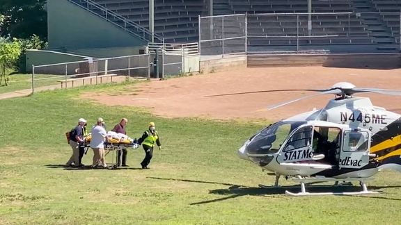 Salman Rushdie being transported to a helicopter to be taken to hospital. August 12, 2022