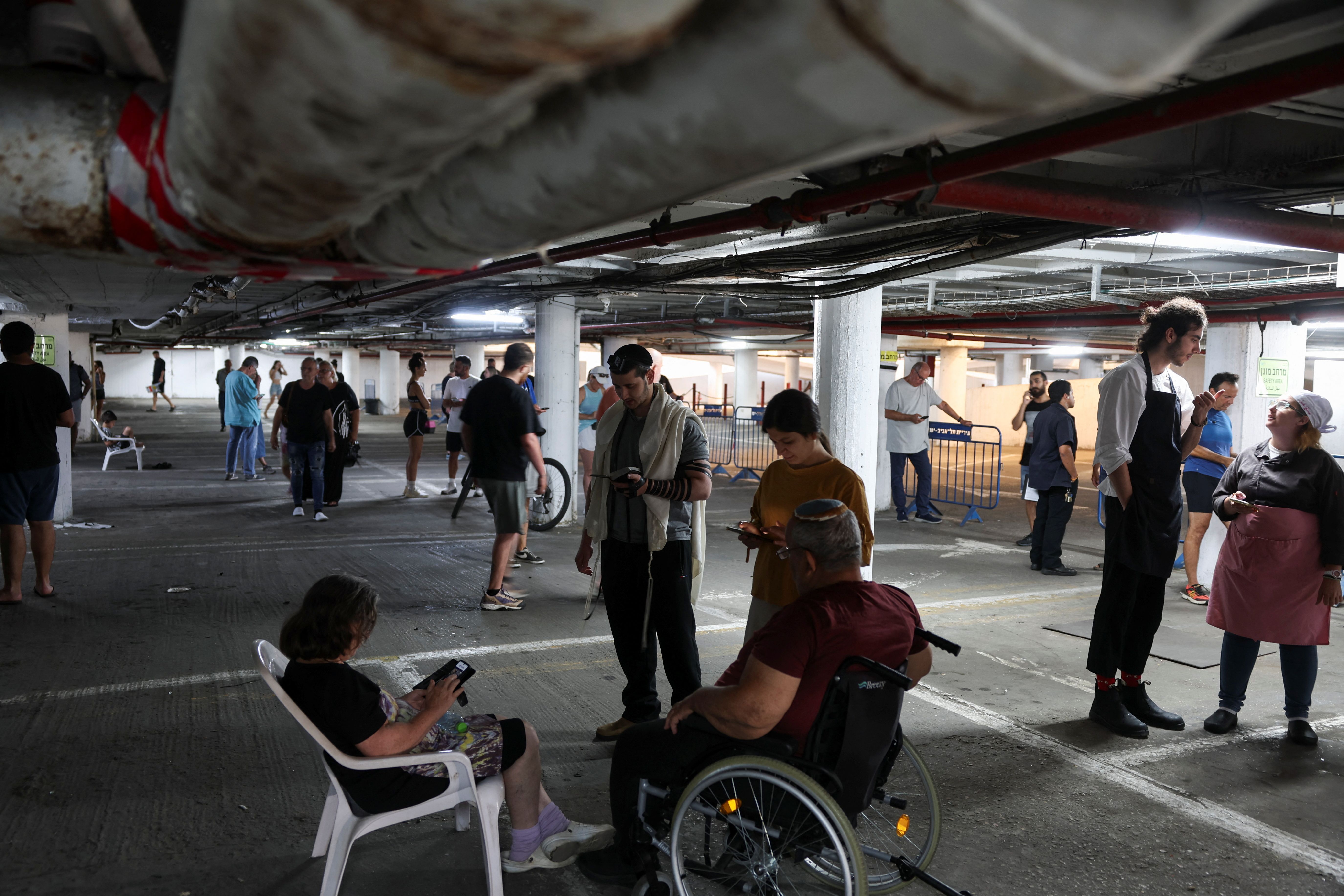 People take shelter amid missile attacks from Iran, in Tel Aviv, Israel, June 17, 2025.