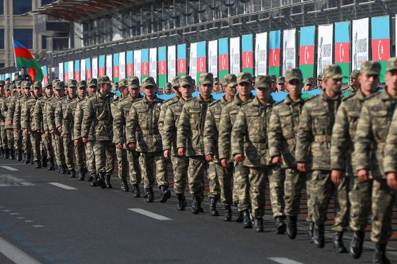 Azeri service members take part in a procession marking the anniversary of the end of the 2020 military conflict over Nagorno-Karabakh breakaway region, involving Azerbaijan's troops against ethnic Armenian forces, in Baku, Azerbaijan, November 8, 2021.