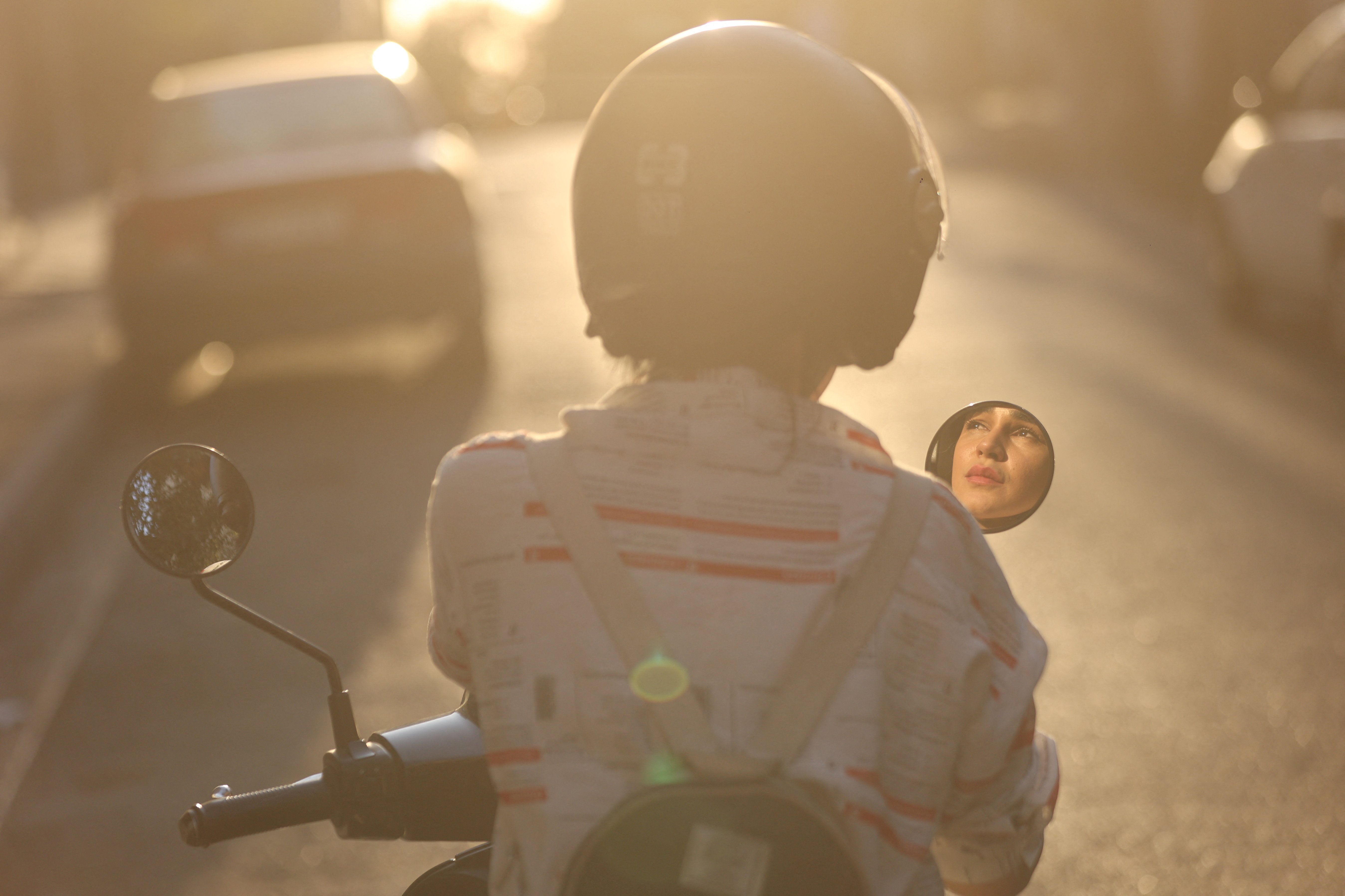 Iranian woman, Bahareh, sits on her motorcycle, while female motorcycling is still not officially legal, in Tehran, Iran, September 7, 2025. 