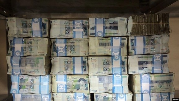 Pile of Iranian rial banknotes that have lost their value eightfold since 2017.