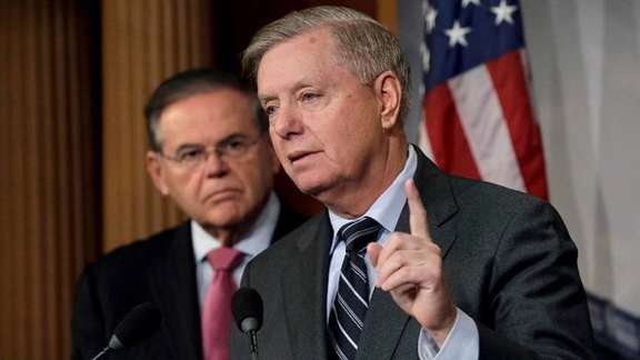 Senator Lindsey Graham speaking as Bob Menendez looks on.