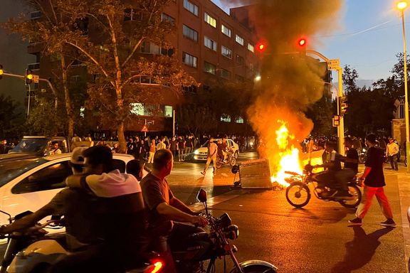 A police motorcycle burns during a protest over the death of Mahsa Amini, a woman who died after being arrested by the Islamic republic's 'morality police', in Tehran, September 19, 2022.