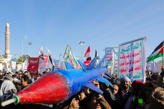 People supporting the Houthis carry a mock missile as they rally against the US-led strikes on Houthi targets, Sana'a, Yemen January 26, 2024.