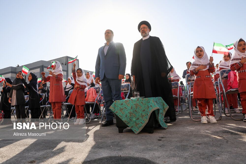Iran’s Education Minister Reza Morad Sahraei (left) and President Ebrahim Raisi among schoolgirls during a ceremony in Tehran  