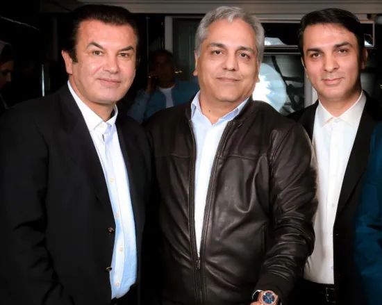 Iran's soccer chief Esteli (L) with a man wanted by the FBI (R) in April