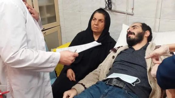 A photo of Hossein Ronaghi receiving medical care after release from prison