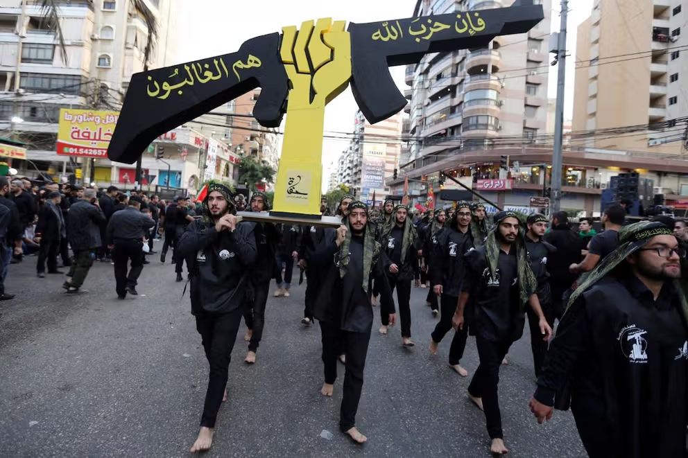 Lebanese Hezbollah supporters carry a replica of Hezbollah emblem during a religious procession to mark Ashura in Beirut's southern suburbs, Lebanon October 12, 2016.