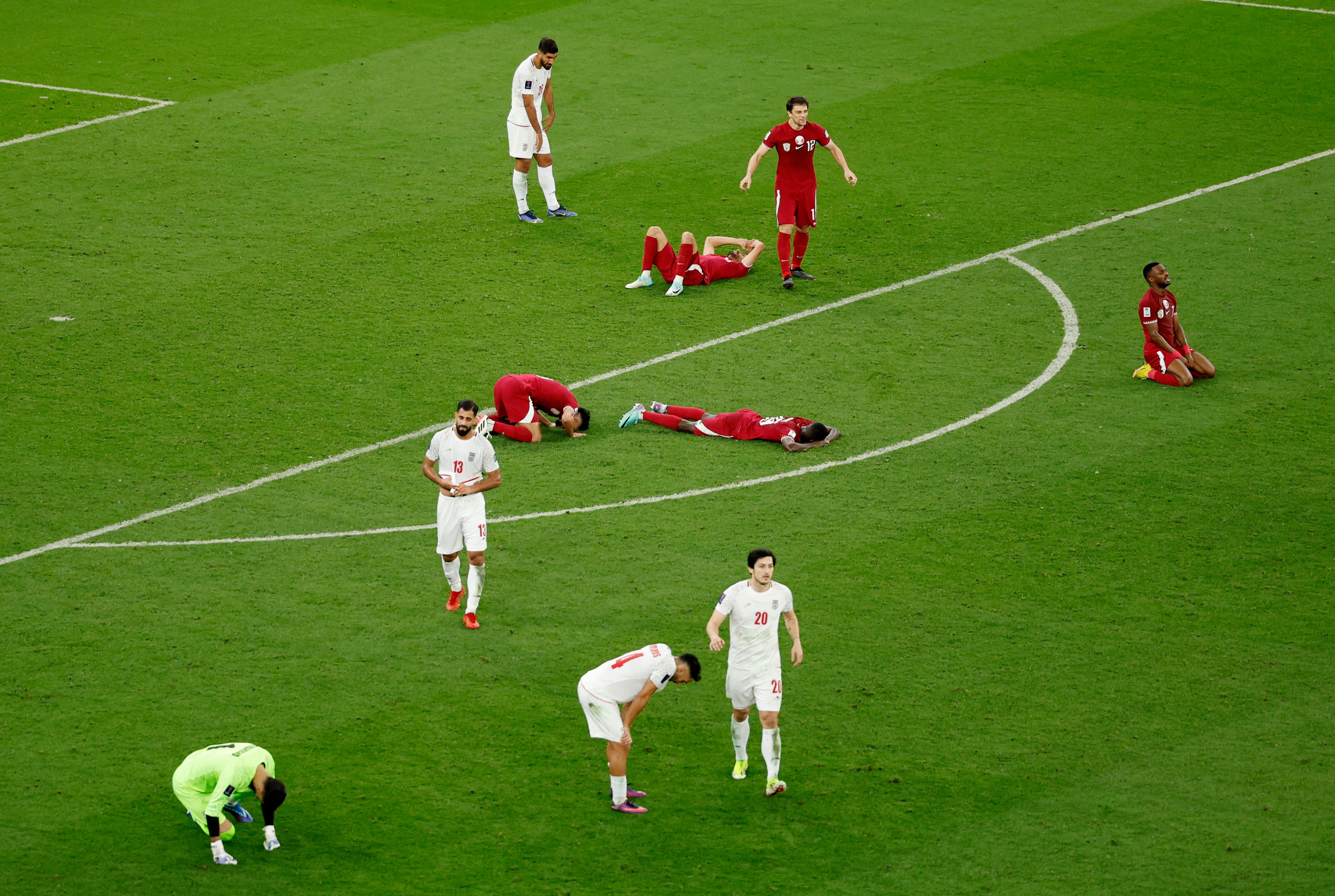 Players react after Qatar defeated Iran in the AFC Asian Cup semifinal match in Doha, Qatar - February 7, 2024 