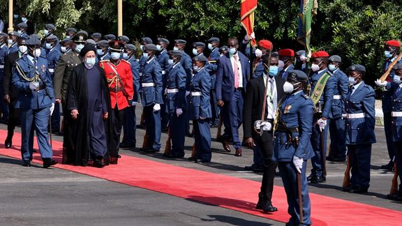 Iranian President Ebrahim Raisi inspects the guard of honor during his official visit at the State House in Entebbe, Uganda, on July 12, 2023.