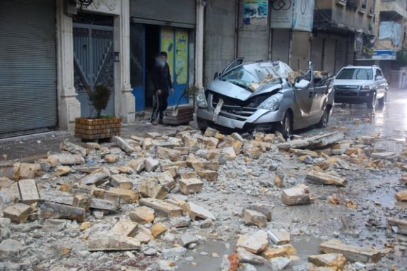 A man stands near a damaged vehicle, following an earthquake, in rebel-held Azaz, Syria February 6, 2023