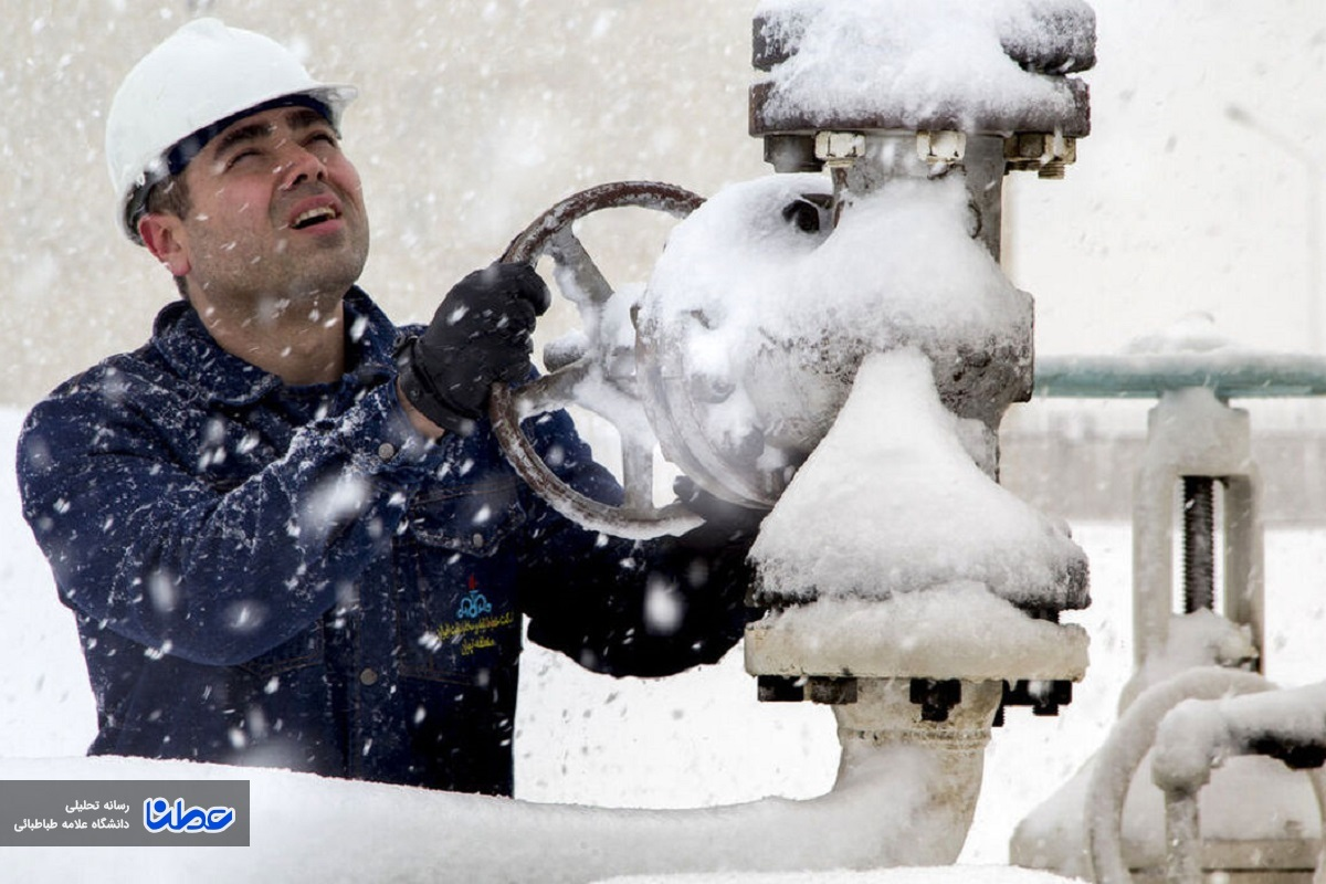 An Iranian energy worker adjusts a valve amid heavy snowfall, highlighting the challenges of maintaining gas flow during winter months.