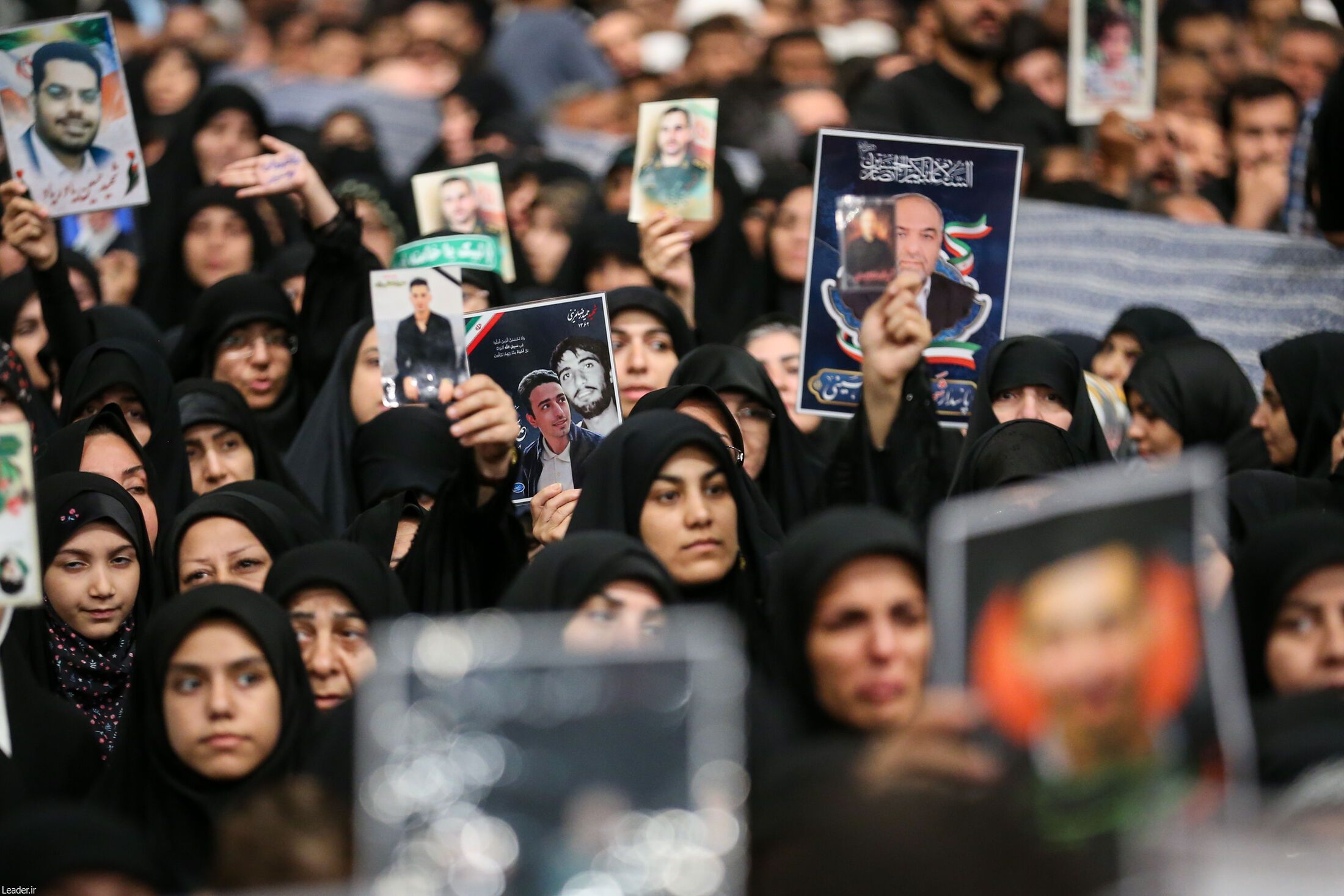 People hold photos of those killed in the recent Israel-Iran conflict during a meeting with Supreme Leader Ali Khamenei in Tehran on July 29, 2025. 