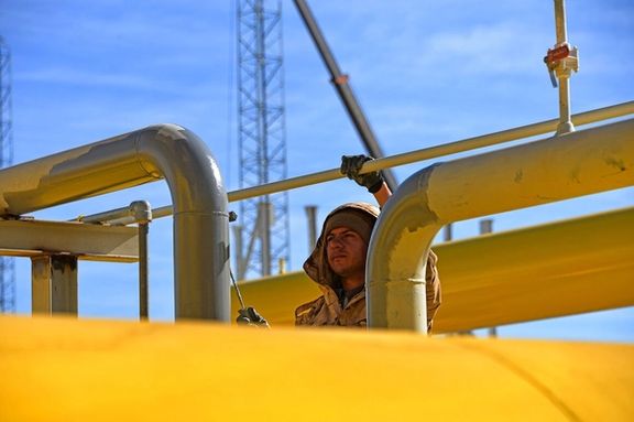 A builder works on the construction of the Dehshir gas pressure-boosting station in Yazd Province