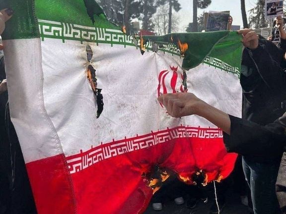 The Islamic Republic's flag is torn and burned by protesters during campus rallies on February 23, 2026
