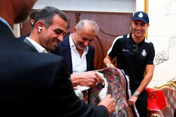 Al Nassr's Cristiano Ronaldo is welcomed upon arrival at Imam Khomeini Airport September 18, 2023.