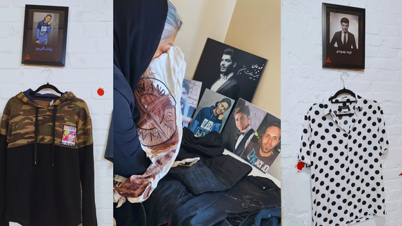 A composite photo of the hoodie worn by slain protester Pezhman Gholipour on display, alongside an image of his mother, Mahboubeh Ramezani, holding the bloodstained shirt he wore during the protests when he was shot and killed, with the shirt worn by slain protester Navid Behboudi also displayed.