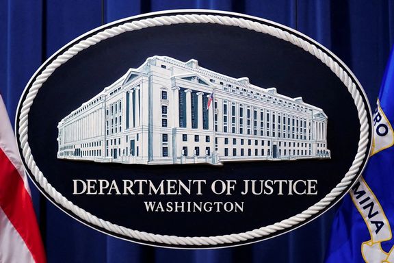 A US Justice Department logo or seal showing Justice Department headquarters, known as "Main Justice," is seen behind the podium in the Department's headquarters briefing room in Washington.
