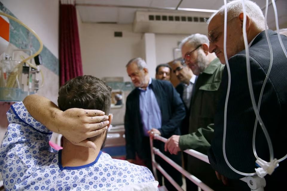 Iran's President Masoud Pezeshkian visits one of the victims injured by pager explosions across Lebanon, in a hospital in Tehran, Iran, September 20, 2024.