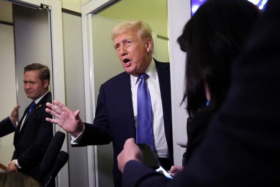 US President Donald Trump speaks to reporters, watched by National Security Advisor Mike Waltz, aboard Air Force One on his return to Washington, DC, March 16, 2025.