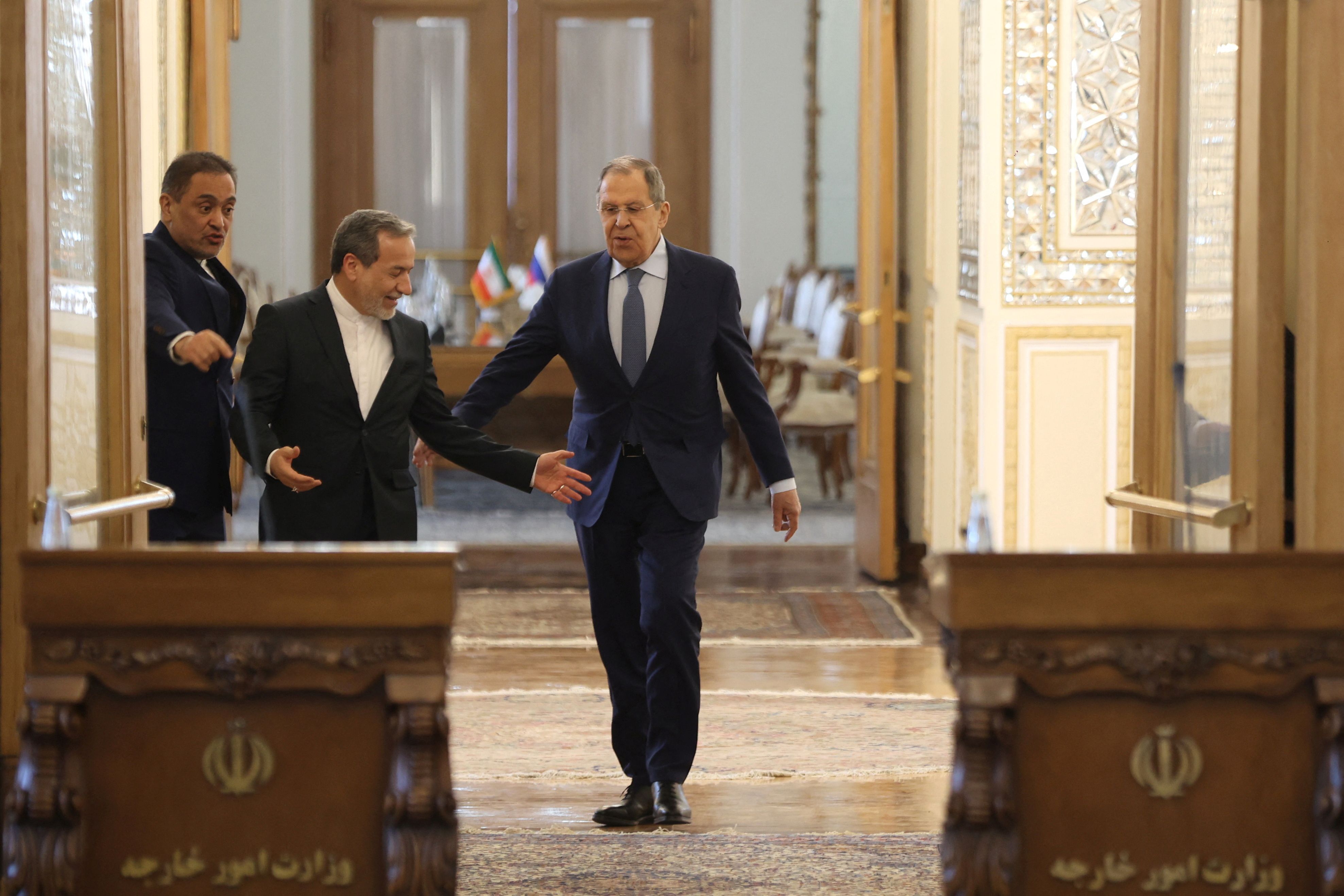 Iranian Foreign Minister Abbas Araghchi and Russia's Foreign Minister Sergei Lavrov enter the hall for a joint press conference in Tehran, Iran, February 25, 2025. 