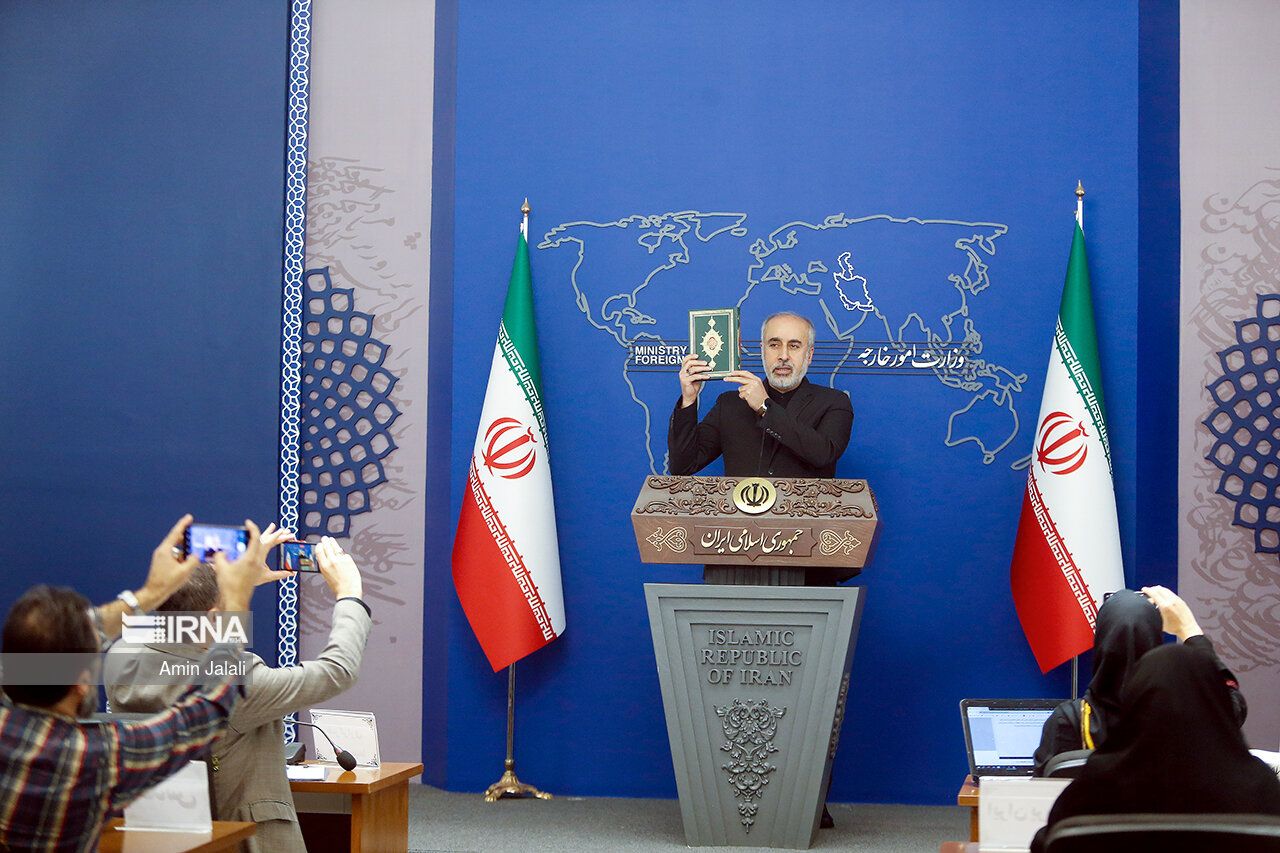 Iranian Foreign Ministry spokesman Nasser Kanaani holding a copy of the Quran during his press conference on July 24, 2023   
