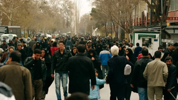 Crowds navigate a busy street in Iran (Undated)