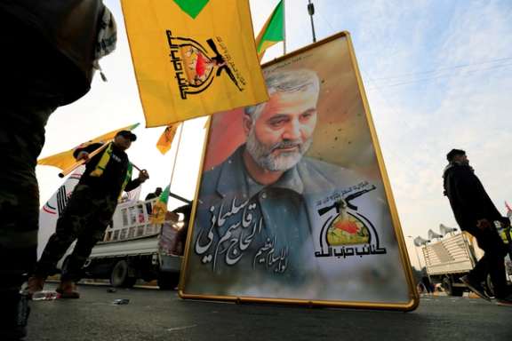 Kataib Hezbollah Iraqi militia hold the picture of the Iranian Major-General Qassem Soleimani, as they gather ahead of the funeral of the Iraqi militia commander Abu Mahdi al-Muhandis, who was killed in an air strike at Baghdad airport, in Baghdad, Iraq, January 4, 2020.