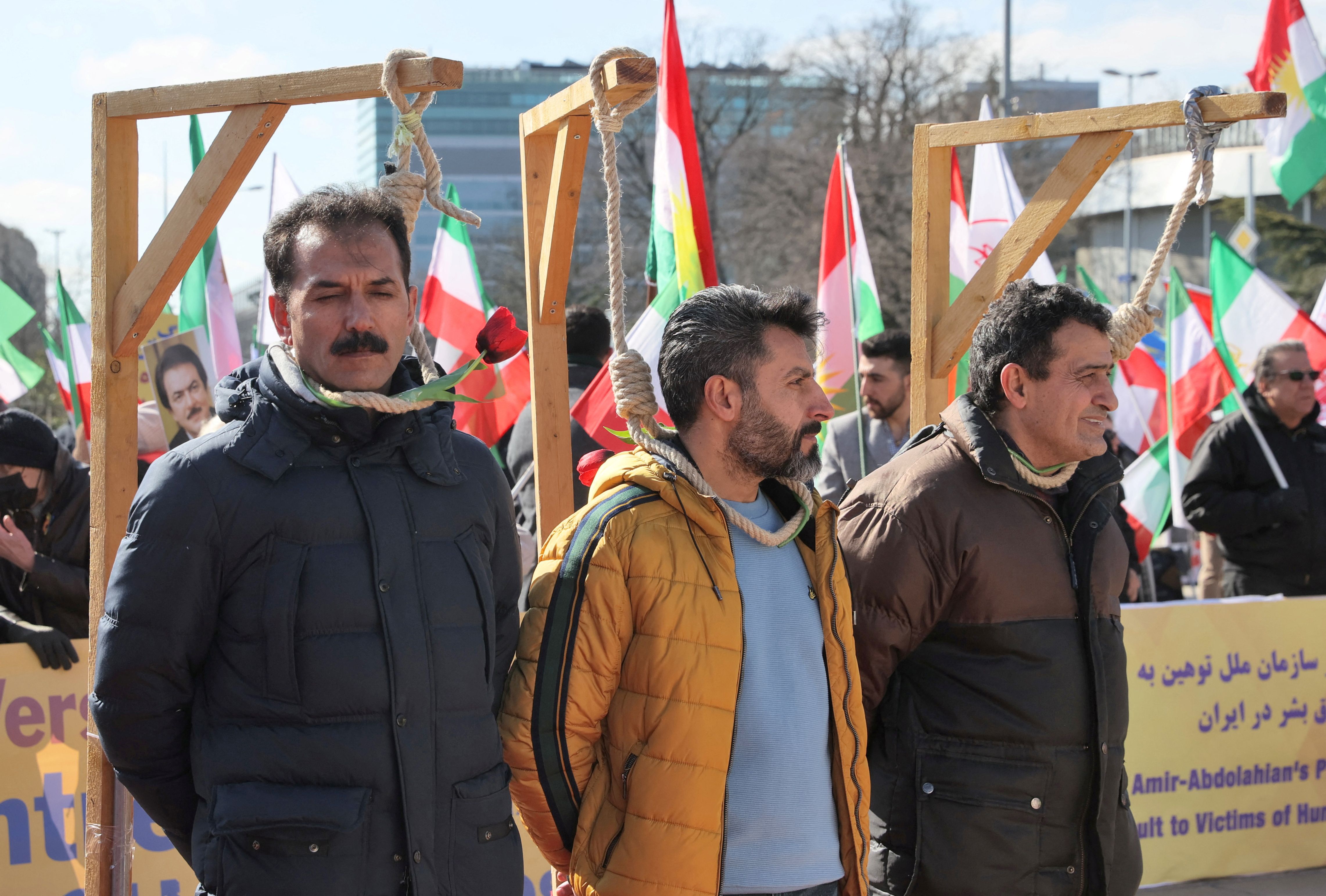 Men, simulating hanging, demonstrate against the Republic of Iran in the Place des Nations during the Human Rights Council at the United Nations in Geneva, Switzerland, February 27, 2023. 